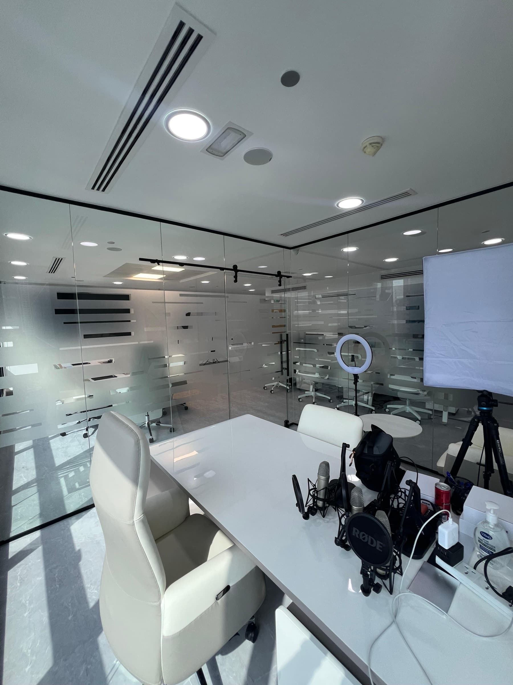 OpenReal recording studio with microphones, lighting, and glass meeting rooms.